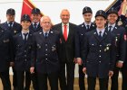 Auf dem Bild ist Innenminister Joachim Herrmann inmitten mehrerer aktiver Feuerwehrkameraden der Freiwilligen Feuerwehr Wemding zu sehen.