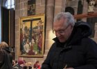 Auf dem Bild ist Innenminister Joachim Herrmann zu sehen, wie dieser in der Lorenzkirche in Nürnberg eine Kerze entzündet.