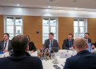 Staatssekretär am Besprechungstisch mit den Gesprächsteilnehmern