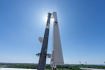 Warnsirene des DRK auf hohem Dach installiert vor sonnigem Himmel