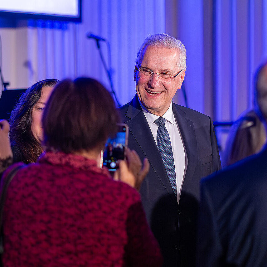 Herrmann im Gespräch vor Bühne inmitten von Leuten