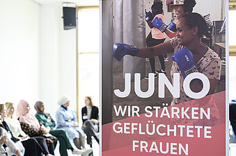 Plakat mit dem Aufdruck JUNO Wir stärken geflüchtete Frauen